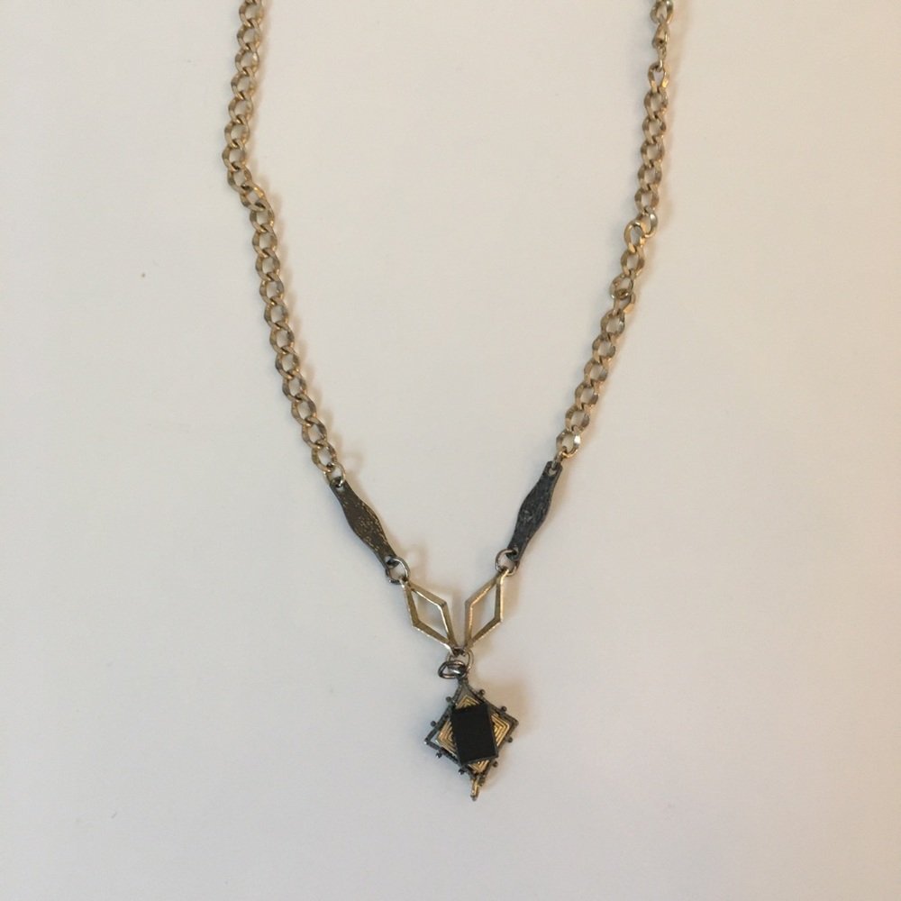 Golden necklace with black stone